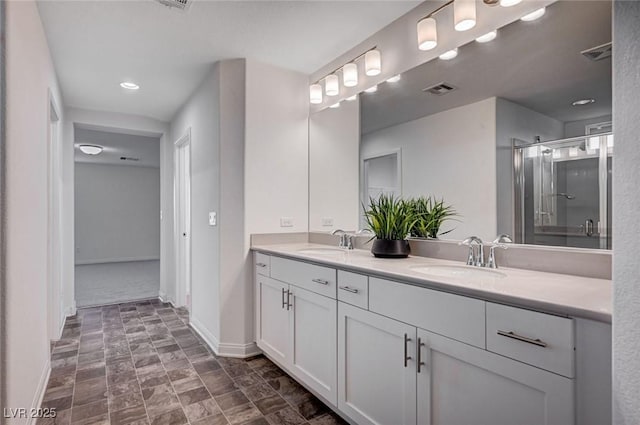 bathroom featuring vanity and a shower with shower door