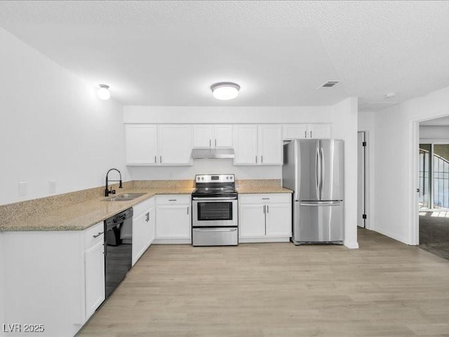 kitchen featuring stainless steel appliances, sink, light hardwood / wood-style flooring, and white cabinets