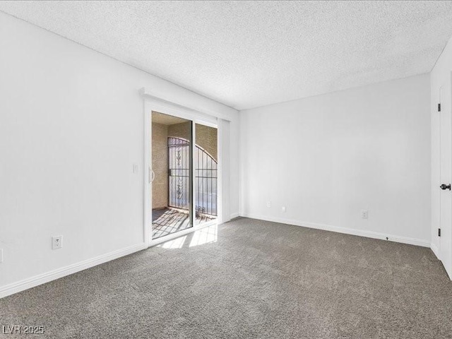 unfurnished room featuring carpet floors and a textured ceiling