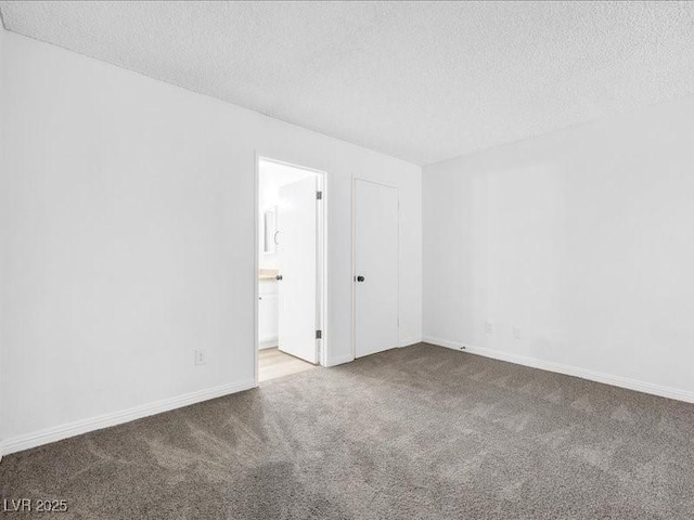 spare room with carpet flooring and a textured ceiling