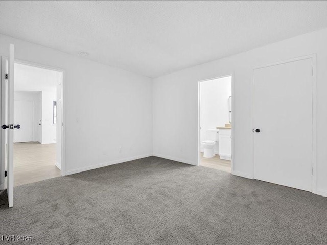 carpeted spare room with a textured ceiling