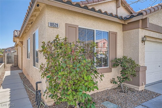 view of side of home featuring a garage