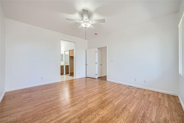 empty room with light hardwood / wood-style flooring and ceiling fan