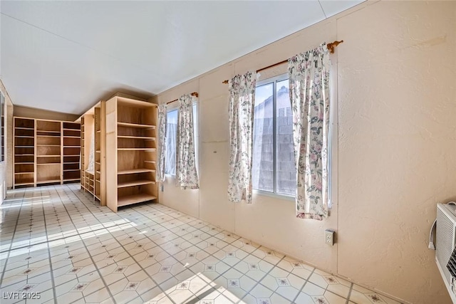 spare room featuring lofted ceiling