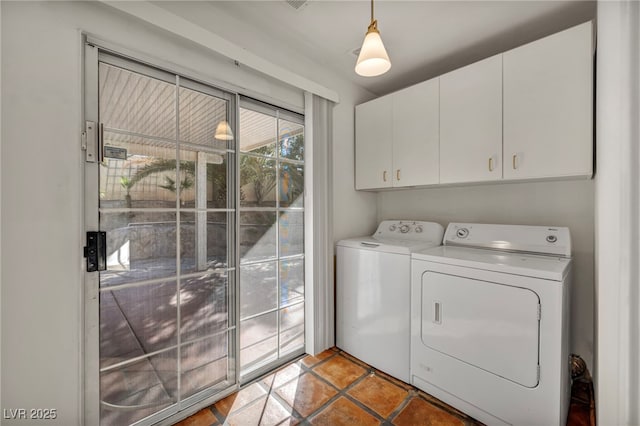 laundry room with cabinets, light tile patterned floors, and independent washer and dryer