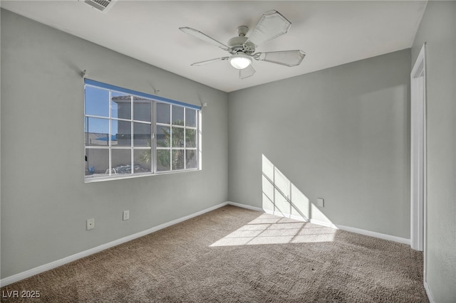 empty room featuring light colored carpet and ceiling fan