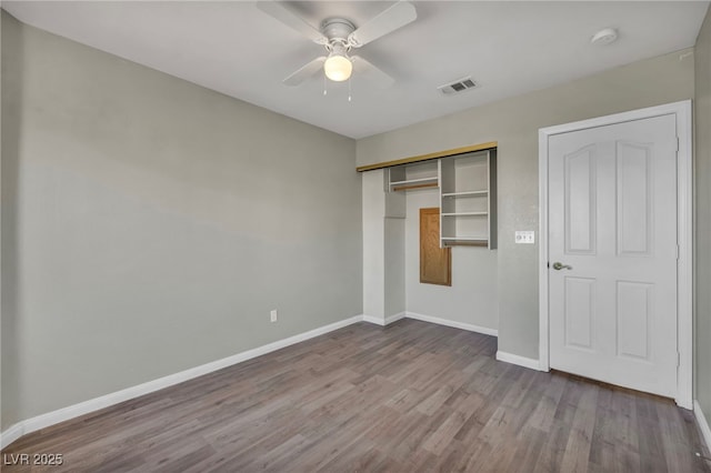 unfurnished bedroom featuring ceiling fan, a closet, and light hardwood / wood-style flooring