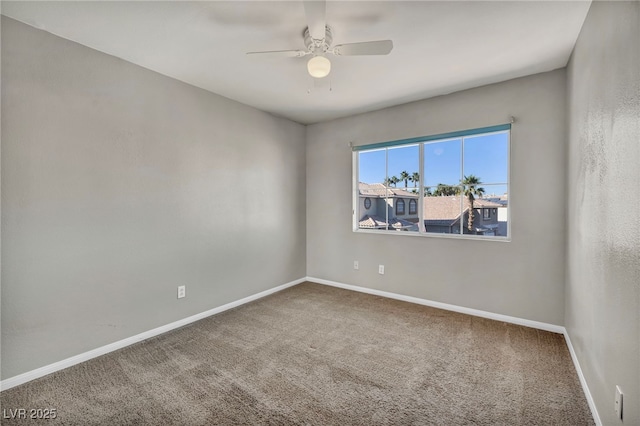 carpeted spare room featuring ceiling fan