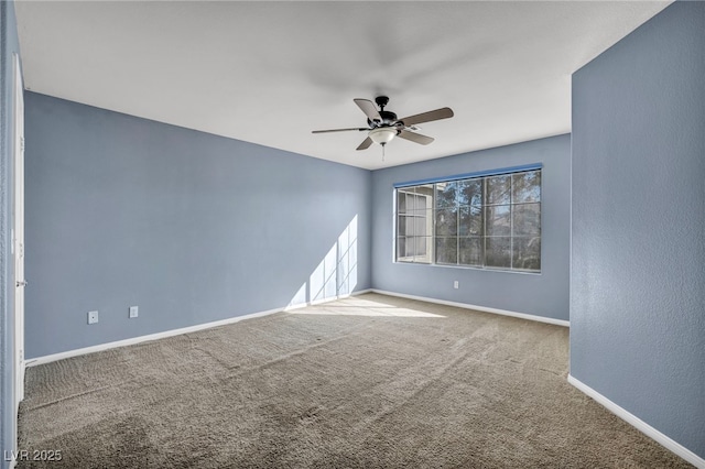 spare room featuring carpet and ceiling fan