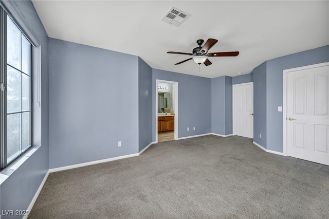 unfurnished bedroom with multiple windows and carpet