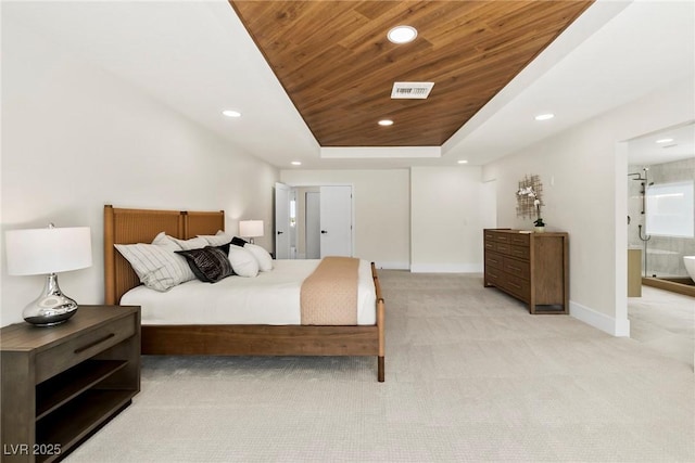 bedroom with light carpet, wood ceiling, ensuite bath, and a raised ceiling