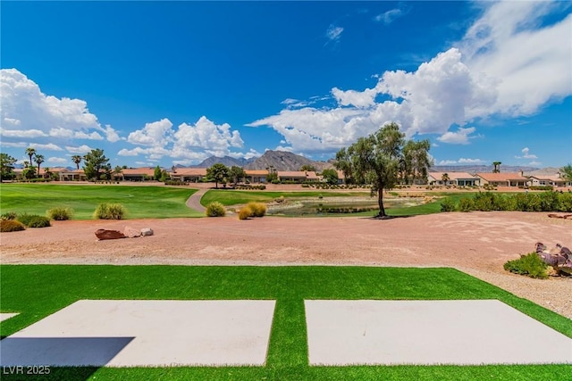 view of community with a yard and a mountain view