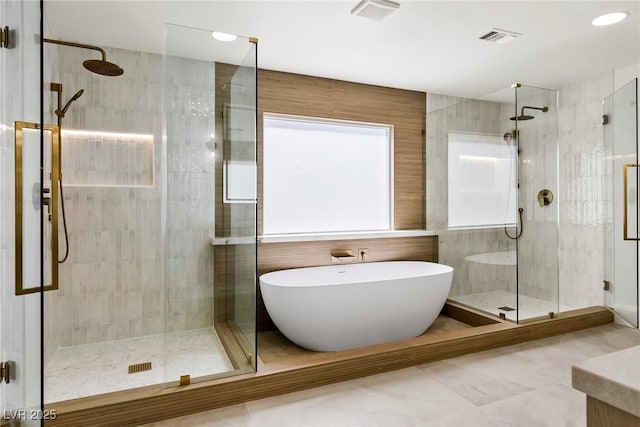 bathroom featuring independent shower and bath and vanity