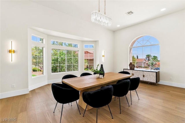 dining area featuring a notable chandelier and light hardwood / wood-style flooring