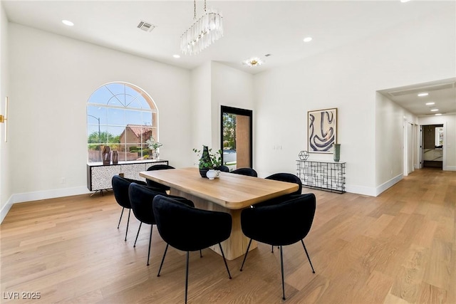 dining area featuring a chandelier and light hardwood / wood-style flooring