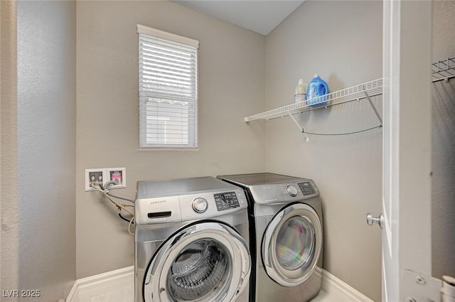 clothes washing area featuring separate washer and dryer