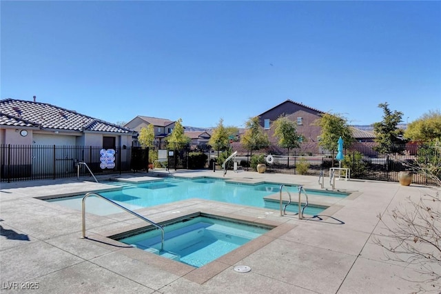 view of swimming pool with a community hot tub and a patio area