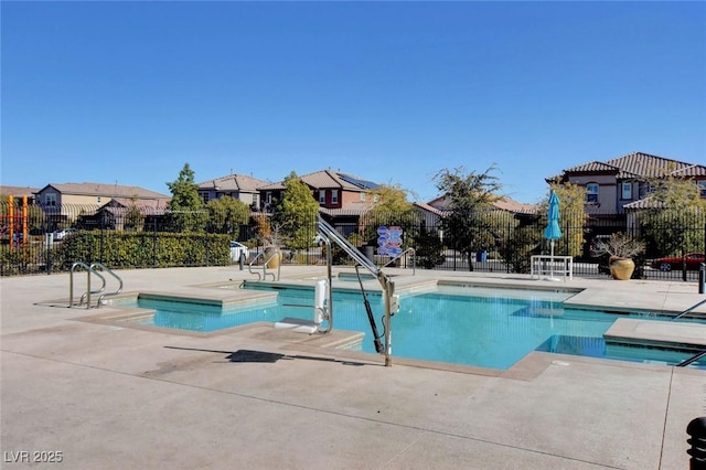 view of pool with a hot tub and a patio