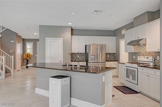 kitchen with an island with sink, sink, white cabinets, white range with gas cooktop, and stainless steel refrigerator with ice dispenser