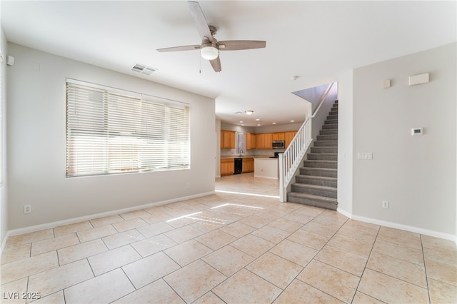 tiled empty room featuring ceiling fan