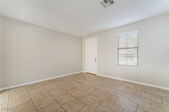 spare room with light tile patterned floors