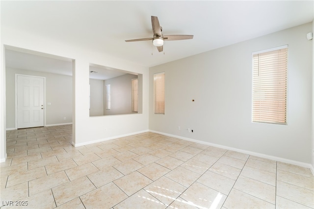 tiled spare room featuring ceiling fan