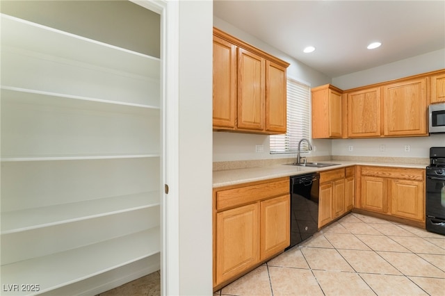 kitchen with light tile patterned floors, sink, and black appliances