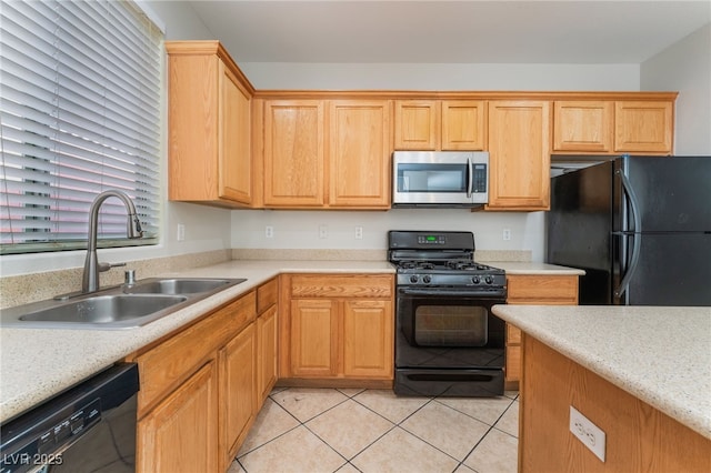 kitchen featuring light tile patterned floors, sink, and black appliances