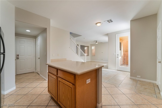 kitchen with light tile patterned flooring and ceiling fan