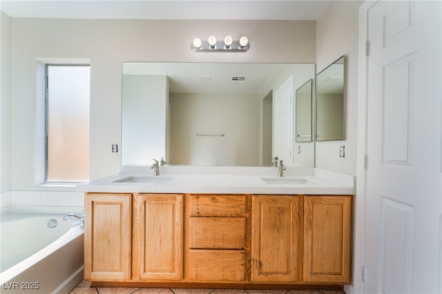 bathroom featuring vanity and a washtub