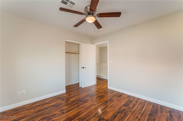 unfurnished bedroom featuring dark wood-type flooring, ceiling fan, and a closet