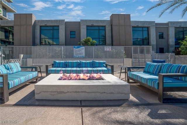 view of patio / terrace with an outdoor living space with a fire pit