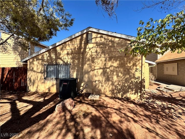 rear view of property with cooling unit