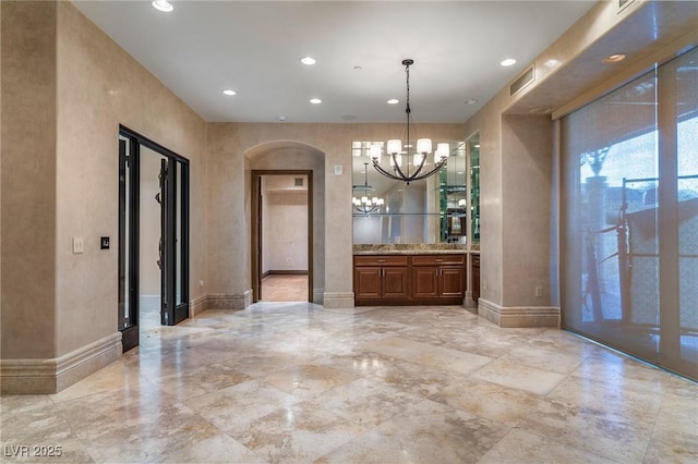 unfurnished dining area with a chandelier