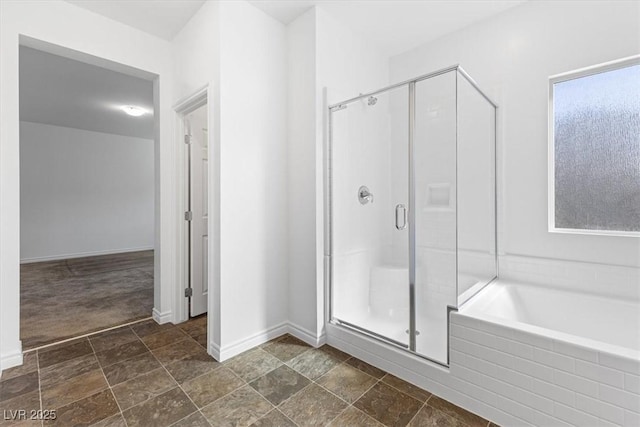 bathroom featuring separate shower and tub