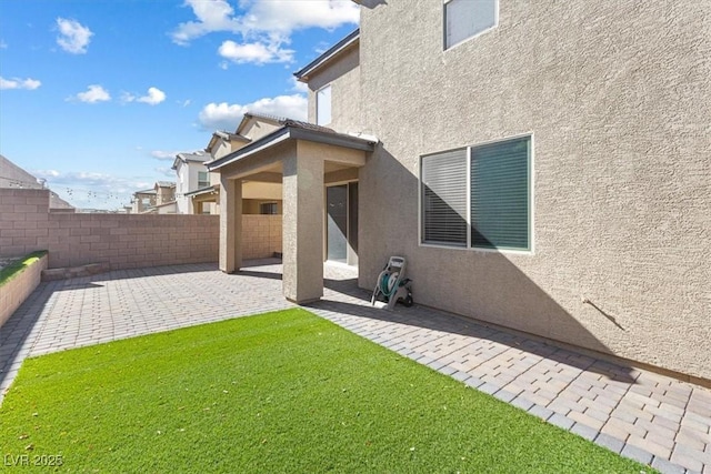 rear view of property with a patio and a yard