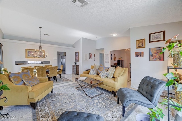 tiled living room with vaulted ceiling, a notable chandelier, and a textured ceiling