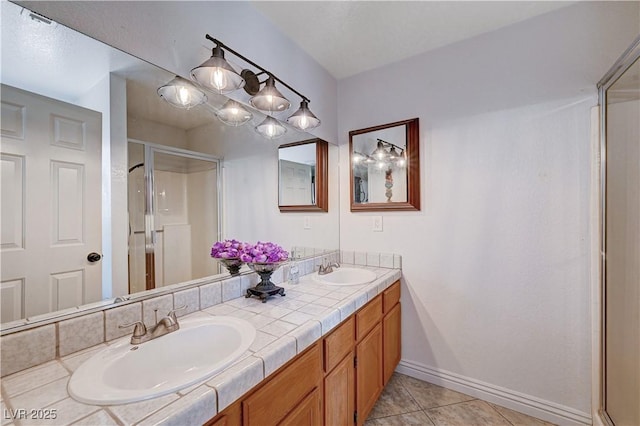 bathroom featuring tile patterned flooring, vanity, and a shower with shower door