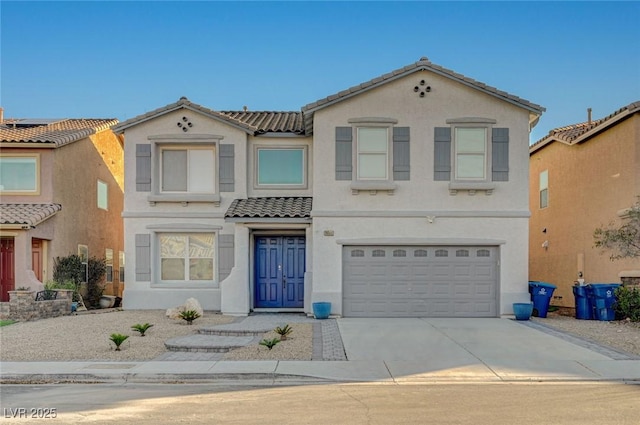 view of front of home with a garage, concrete driveway, a tiled roof, and stucco siding