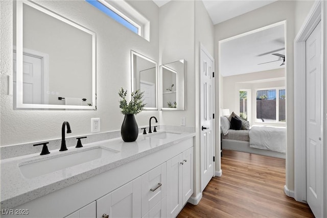 bathroom featuring ceiling fan, vanity, and hardwood / wood-style floors