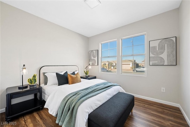 bedroom with dark hardwood / wood-style flooring