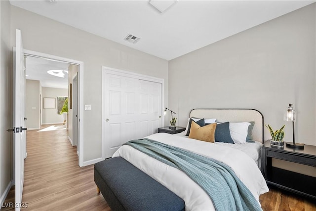 bedroom with wood-type flooring and a closet