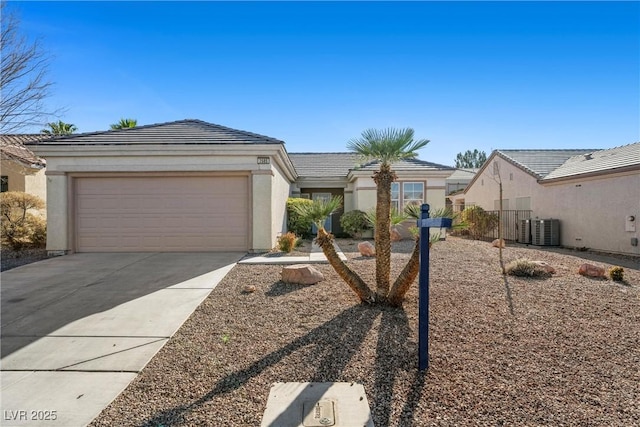 single story home with cooling unit and a garage