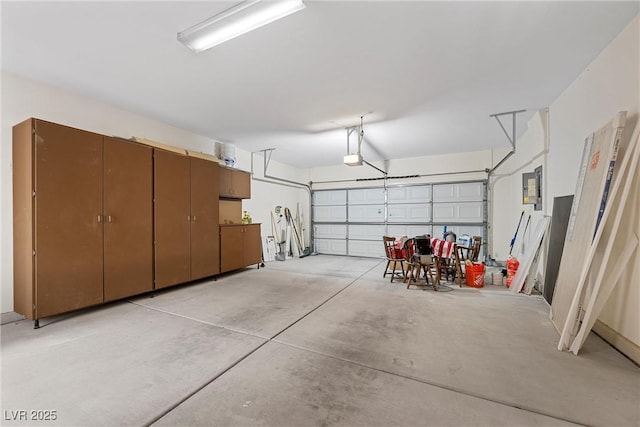 garage featuring a garage door opener and electric panel