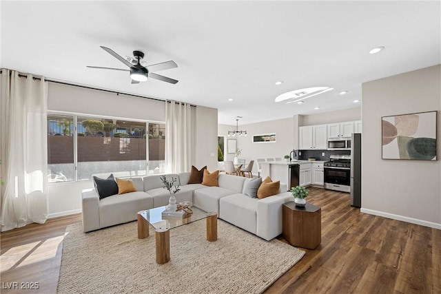 living room with sink, dark hardwood / wood-style floors, and ceiling fan