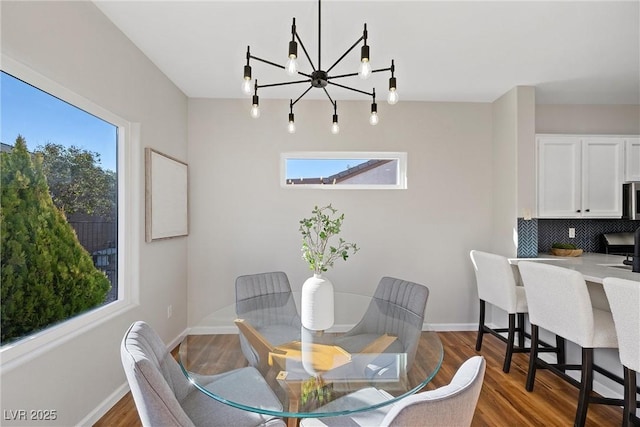 dining room with wood-type flooring and a chandelier