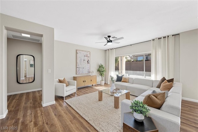 living room with ceiling fan and wood-type flooring