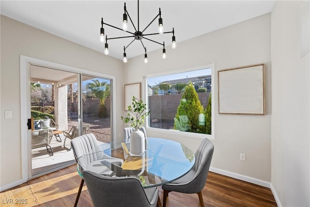 dining room featuring dark hardwood / wood-style floors and a notable chandelier