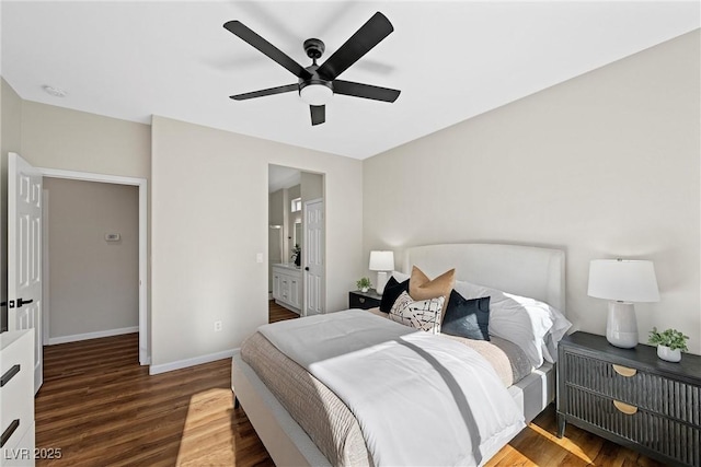 bedroom with ceiling fan, ensuite bathroom, and dark hardwood / wood-style floors