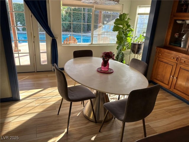 dining space with light wood-type flooring